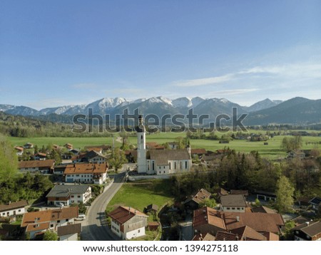 Aerial view of old Bavarian village with alps in the background 