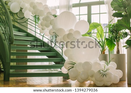 Beautiful green stairs decorated with white balloons