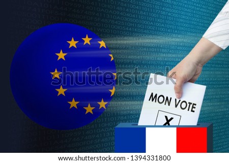 woman's hand puts a white sheet, the symbol of the election ballot with the inscription in French "my vote" in the ballot box against the background of the European Union globe