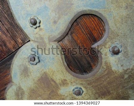 Close up picture of a beautiful iron detail with a hear shaped frame located on an entrance door at the Todai-ji temple in Nara, Japan