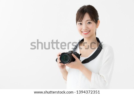 attractive asian woman using camera on white background