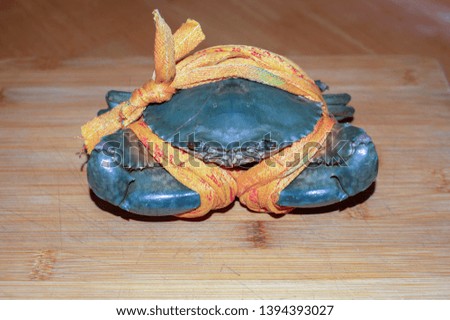 Crabs with large bundles and flowers laid flat on the cutting board