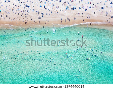 Bondi Beach aerial view on a perfect summer day with people swimming and sunbathing. Bondi is one of Sydney’s busiest beaches and is located on the East Coast of Australia Royalty-Free Stock Photo #1394440016