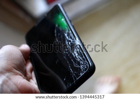 broken black phone in hand
