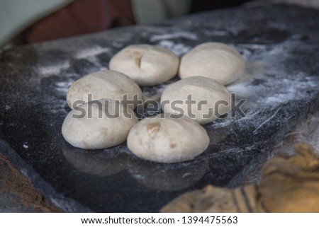 Picture of loyia. It Refers to making the wheat powder to in round size. process of making chapati