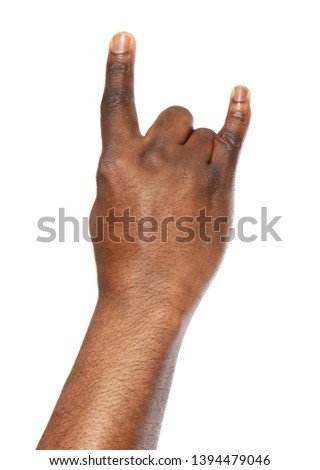 African-American man showing ROCK gesture on white background, closeup