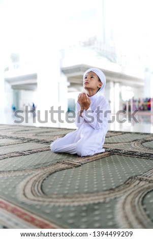 Concept of Asian Muslim Child praying to God