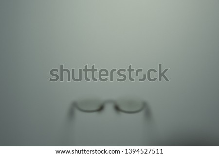 shadow glasses of a man behind a frosted glass. blurred glasses  