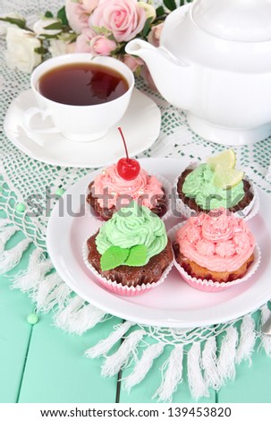 Delicious beautiful  cupcakes on dining table close-up