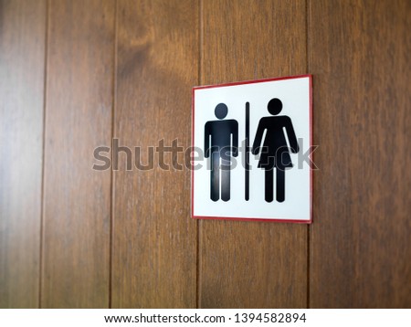 WC / Toilet sign, man and lady icon on wooden background with copy space.