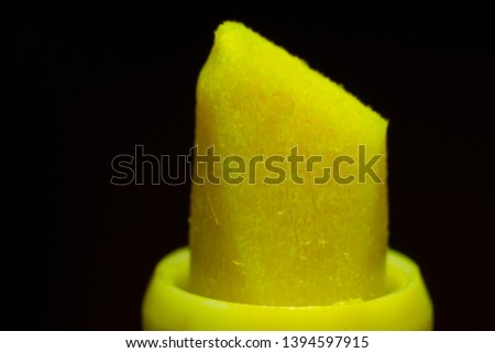 Yellow highlighter macro isolated on black background