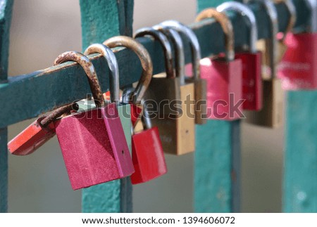 Colorful rusty love locks on a railing of a bridge in Cologne.