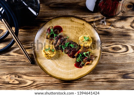 Grilled beef steak with red wine. On rustic background.