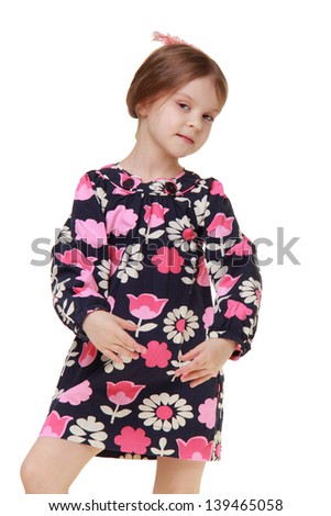 Beautiful happy little girl in a bright dress with a charming hairstyle fresh gerbera
