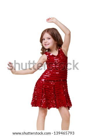 Little girl in a shiny red dress dancing