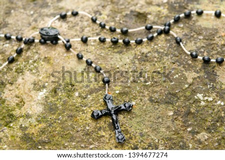 Rosary beads left on a stone Royalty-Free Stock Photo #1394677274