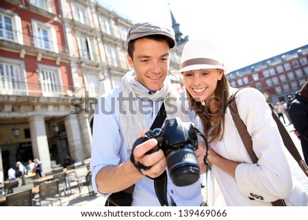 Couple looking at picture shots of Spanish travel journey