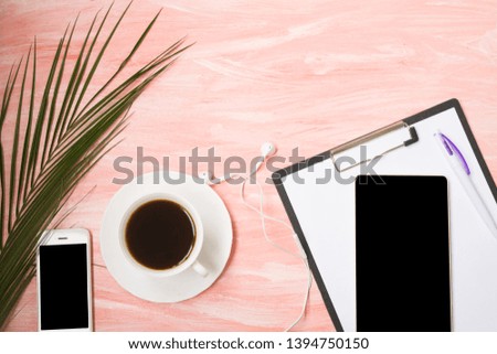 Tropical palm leaves, phone, camera, tablet,  headphones and coffee on a pink background. Flat lay, top view. Copy Space, using for business background