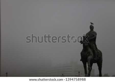 black and white equestrian statue in a foggy environment with shadowed face in Porto, Portugal