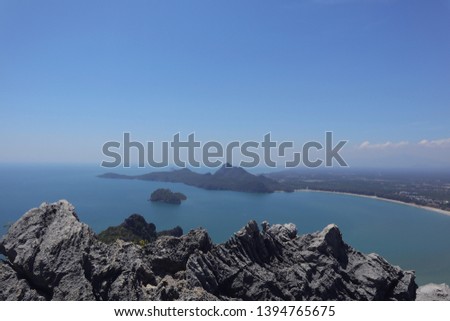 Beautiful landscape view turquoise blue sea ocean beach island and city from high hill stone mountain with blue sky in holiday summer wallpaper background 