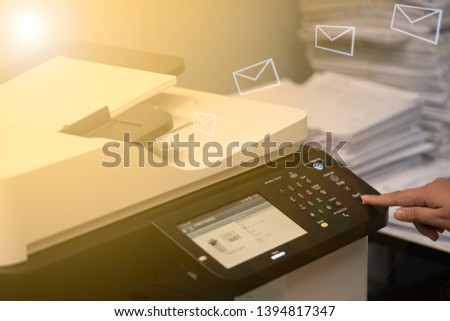 Multifunction machine scanning documents and sending to email. Royalty-Free Stock Photo #1394817347
