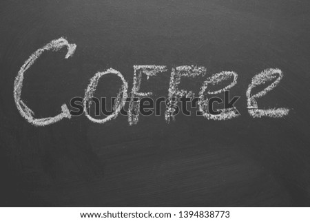 Hand-written chalk inscription "coffee" on a gray board