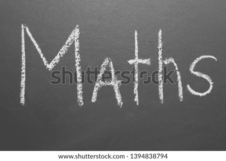 Handwritten inscription in chalk "maths" on a gray board