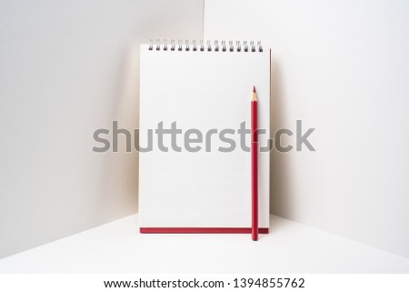 Design concept - perspective view of red spiral notebook, white page on white 3D space background for mockup, it's real photo, not 3D render