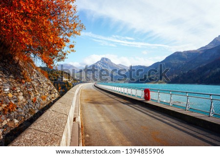 Road on dam on Roselend lake (Lac de Roselend). France Alps (Auvergne-Rhone-Alpes). Landscape photography