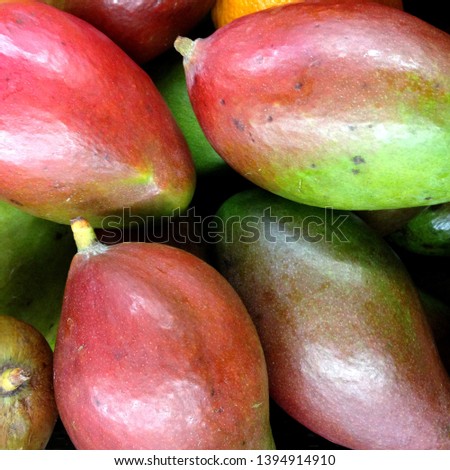 Macro photo food product tropical fruit mango. Texture green and red juicy fresh mango fruit.