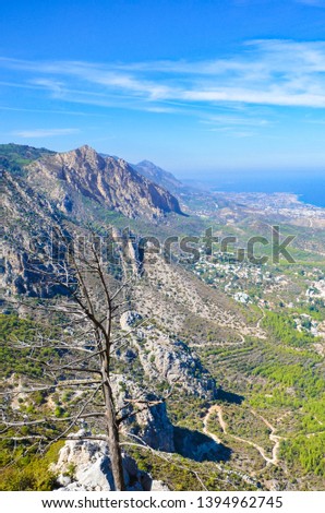 Vertical picture of beautiful Kyrenia region and Mediterranean in Northern Cyprus taken from the ancient Saint Hilarion Castle. The Kyrenia mountain range by the sea is a popular tourist destination.
