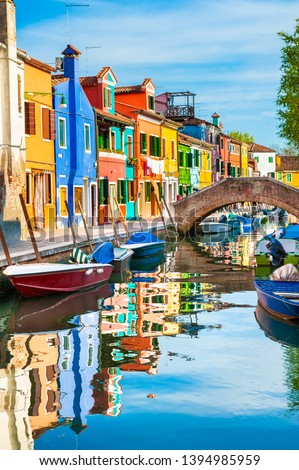 Colorful houses on the canal in Burano island, Venice, Italy. Famous travel destination Royalty-Free Stock Photo #1394985959