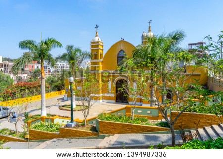 Peru, Lima Barranco, beautiful Yellow church with Palm trees and flowers on sunny morning. Royalty-Free Stock Photo #1394987336
