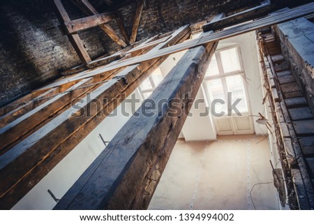 empty attic / loft during dry rot renovation, old roof beams Royalty-Free Stock Photo #1394994002