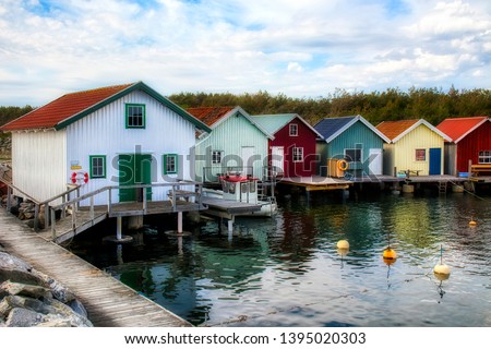 Afternoon with Fisherman’s Cabins at the Beautiful Breviks Fishing Harbor on the Southern Koster Island, Sweden Royalty-Free Stock Photo #1395020303