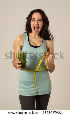Fitness woman smiling happy with diet plan to loose weight; exercise and green vegetable smoothie healthy drink. In Beauty body care, Health Fitness Diet Nutrition and healthy Lifestyle concept.