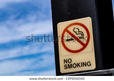 No smoking sign and blue sky with clouds