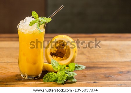 Drinks of the world. Passion fruit drink on a wooden table. Royalty-Free Stock Photo #1395039074