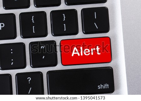 Alarm concept. Alert word on red computer keyboard button