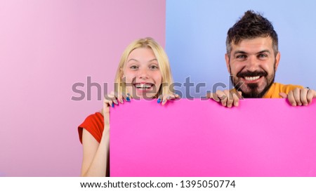 Smiling couple holding advertising board. Advertising. Sale. Online shopping. Advertising banner. Seasons sale. Discount. Black friday. Marketing. Add. Copy space for text.