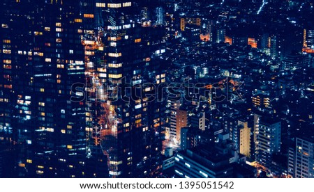 Cityscape at night with office buildings and high-rise skyscrapers