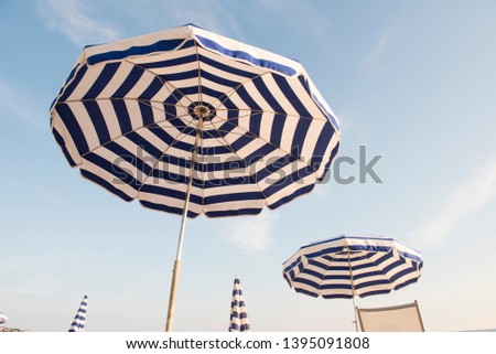 Stripes Beach Umbrella’s on the Beach Royalty-Free Stock Photo #1395091808