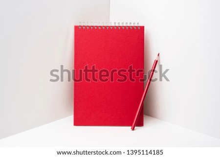 Design concept - perspective view of red spiral notebook, white page on white 3D space background for mockup, it's real photo, not 3D render