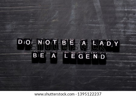 Don't be a lady. Be a legend on wooden blocks. Education, Motivation and inspiration concept