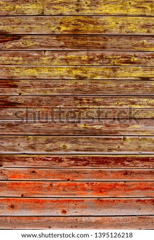 Weathered grungy rustics fence with the place for text, painted half in orange half in yellow colors