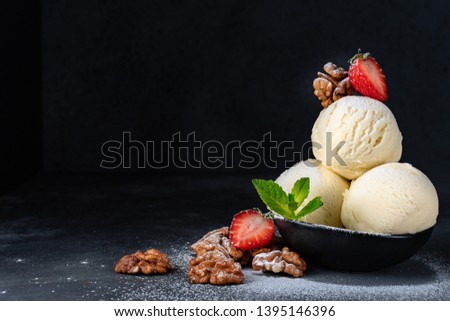  ice cream balls  with strawberries and walnuts on a dark background, selective focus and copy space, Italian gelato, recipe  ice cream, recipe menu background