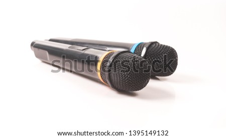 Black color cordless microphone isolated on white background. Concept of singing and public speaking.