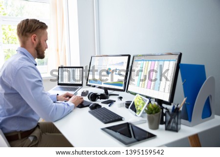 Businessman Working With Spreadsheets On Desktop Computer