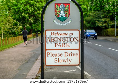 abington park entrance sign between footpath and road in northampton england uk
