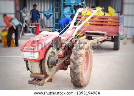 
Farmers use a small tractor to carry rice, taken as a blurred image